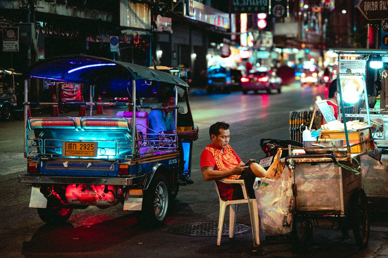 Night street scene with many lights in Chinatown, Bangkok.
